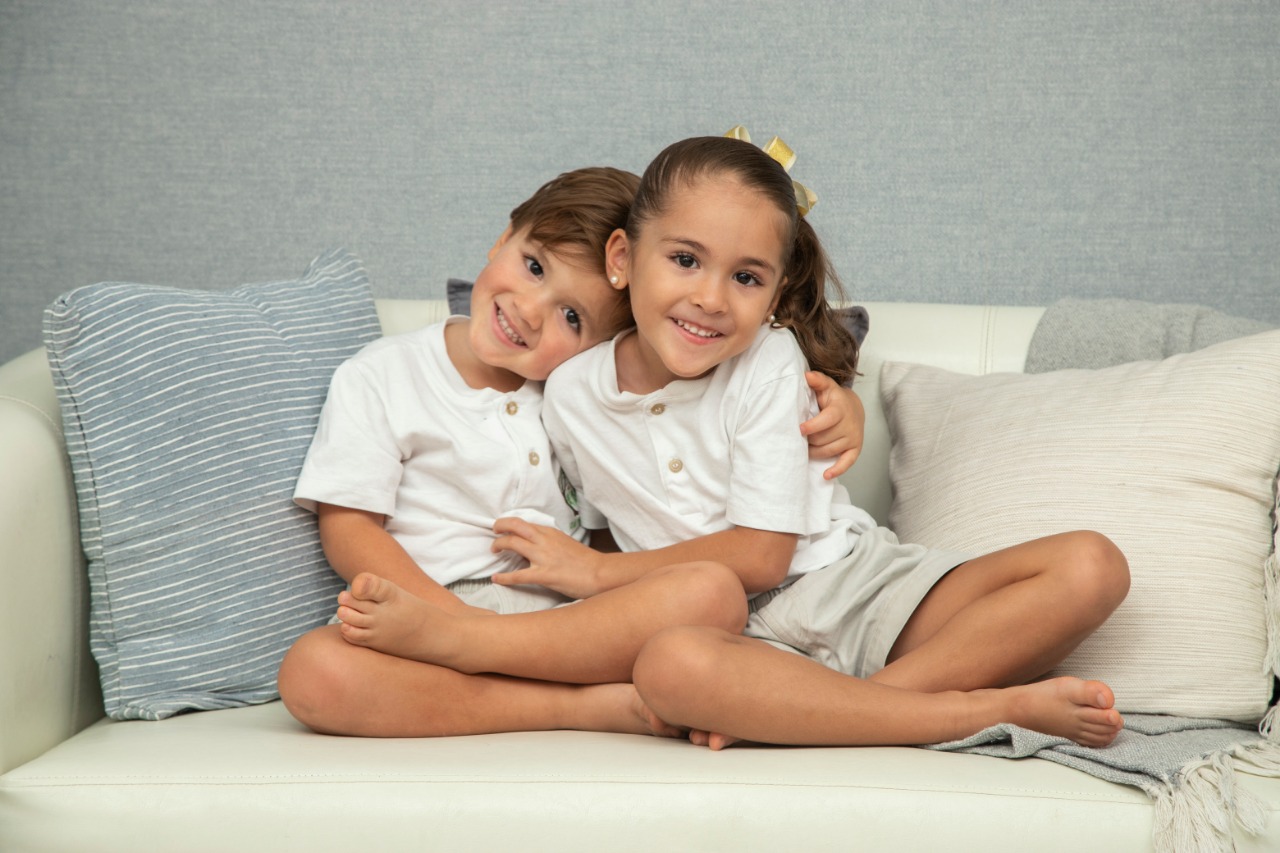 young siblings together on couch
