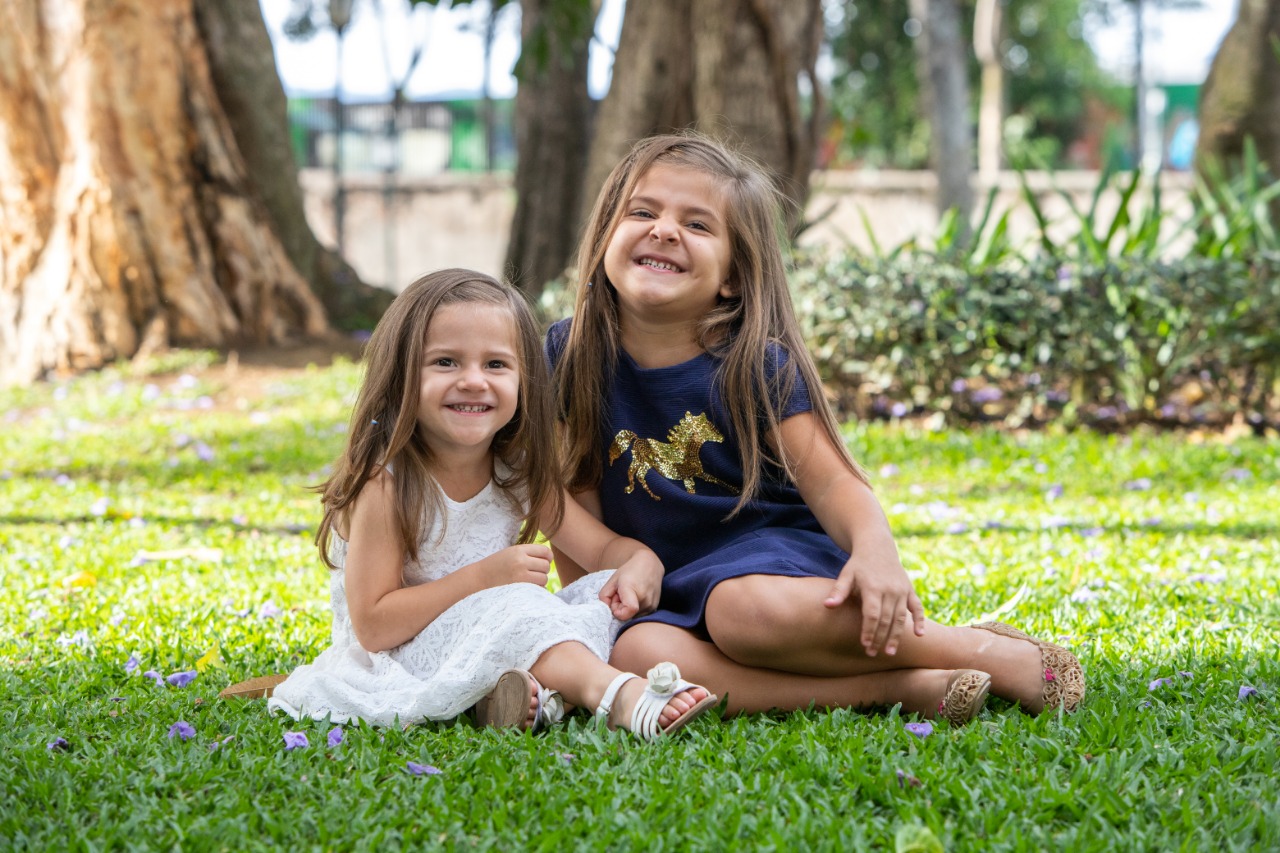 2 girls smiling on grass